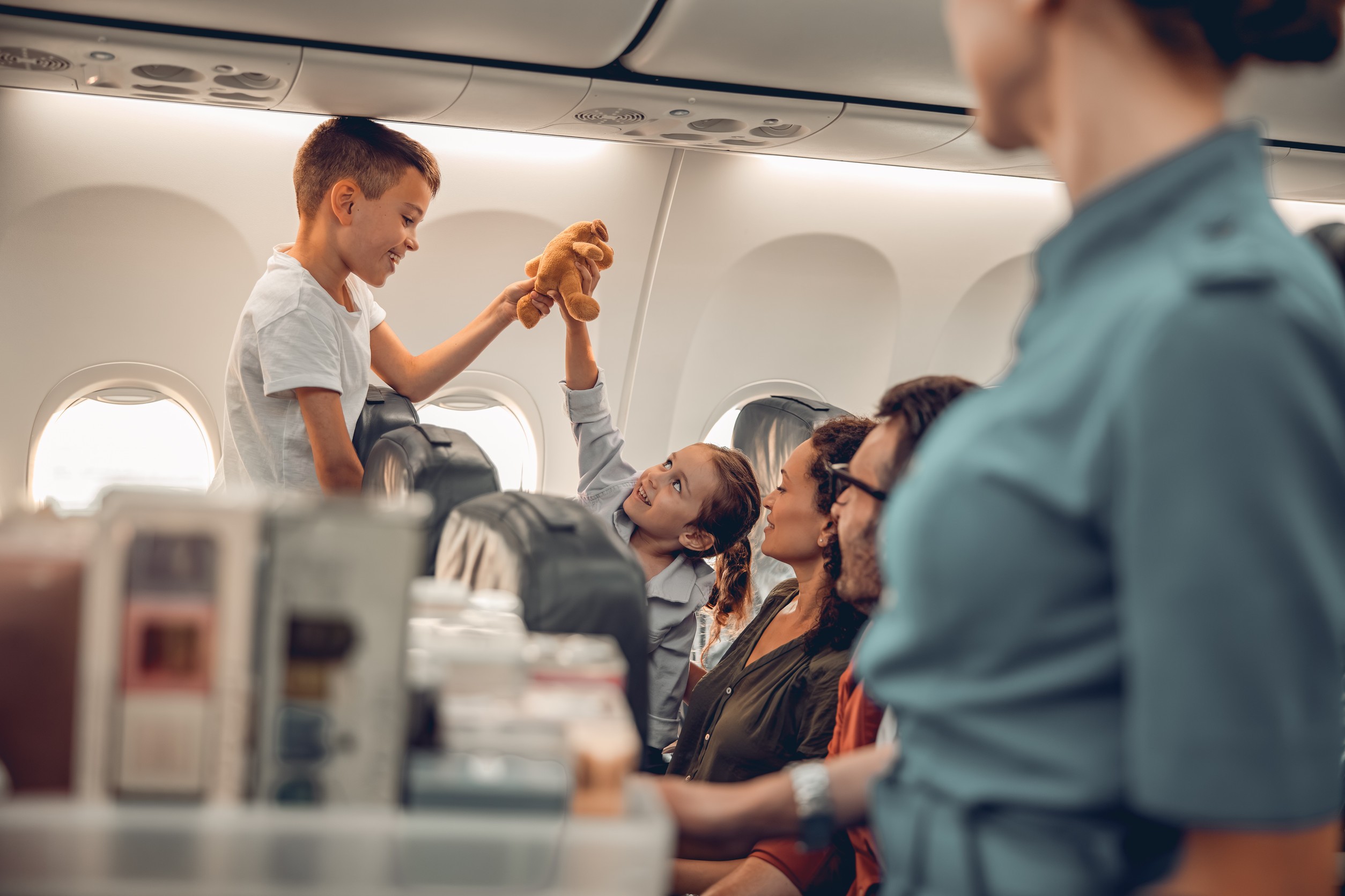 Kids happily play on a plane with family, making memories. Kids happily play on a plane with family, making memories.