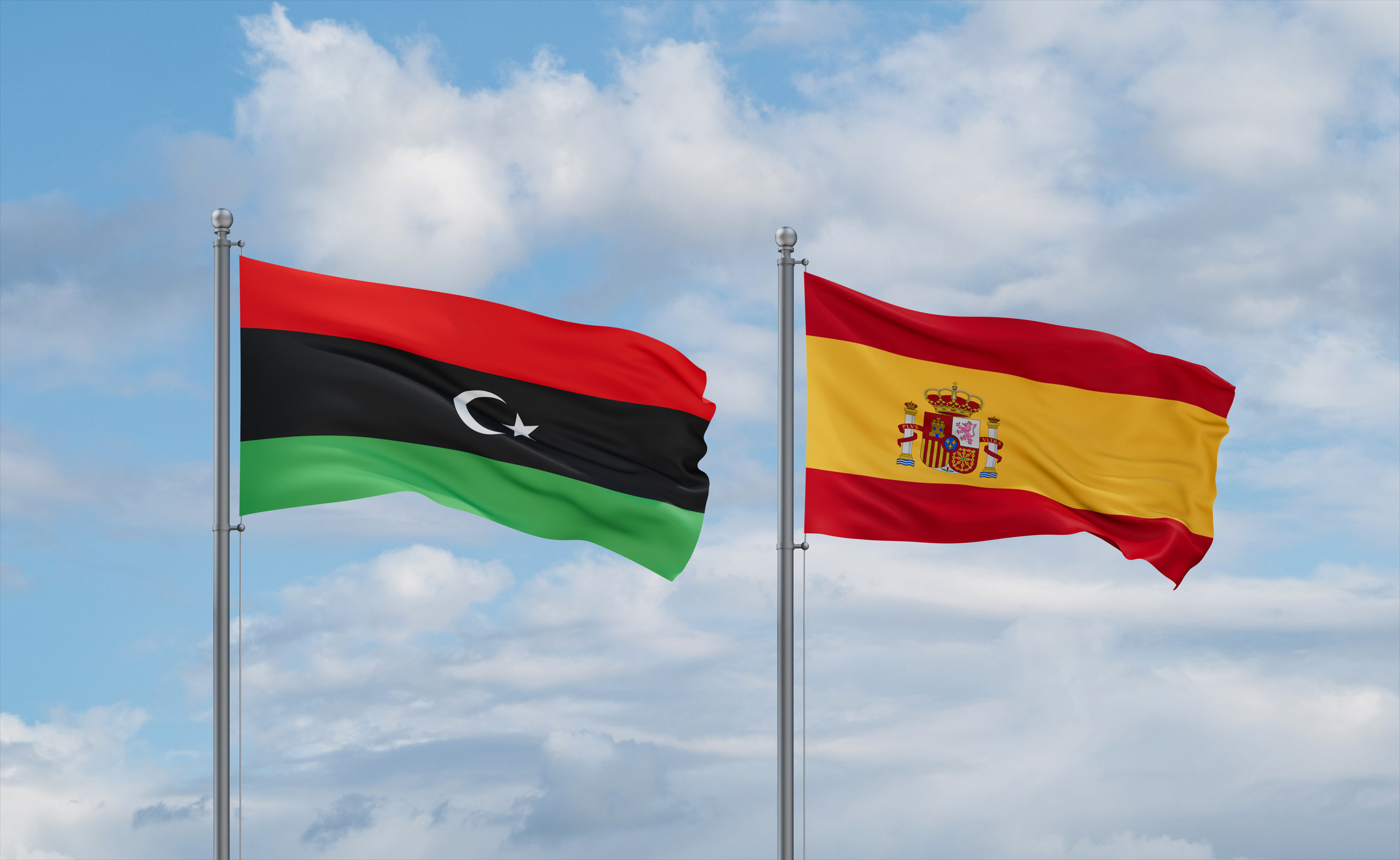 Libya and Spain flags together Libya and Spain flags together