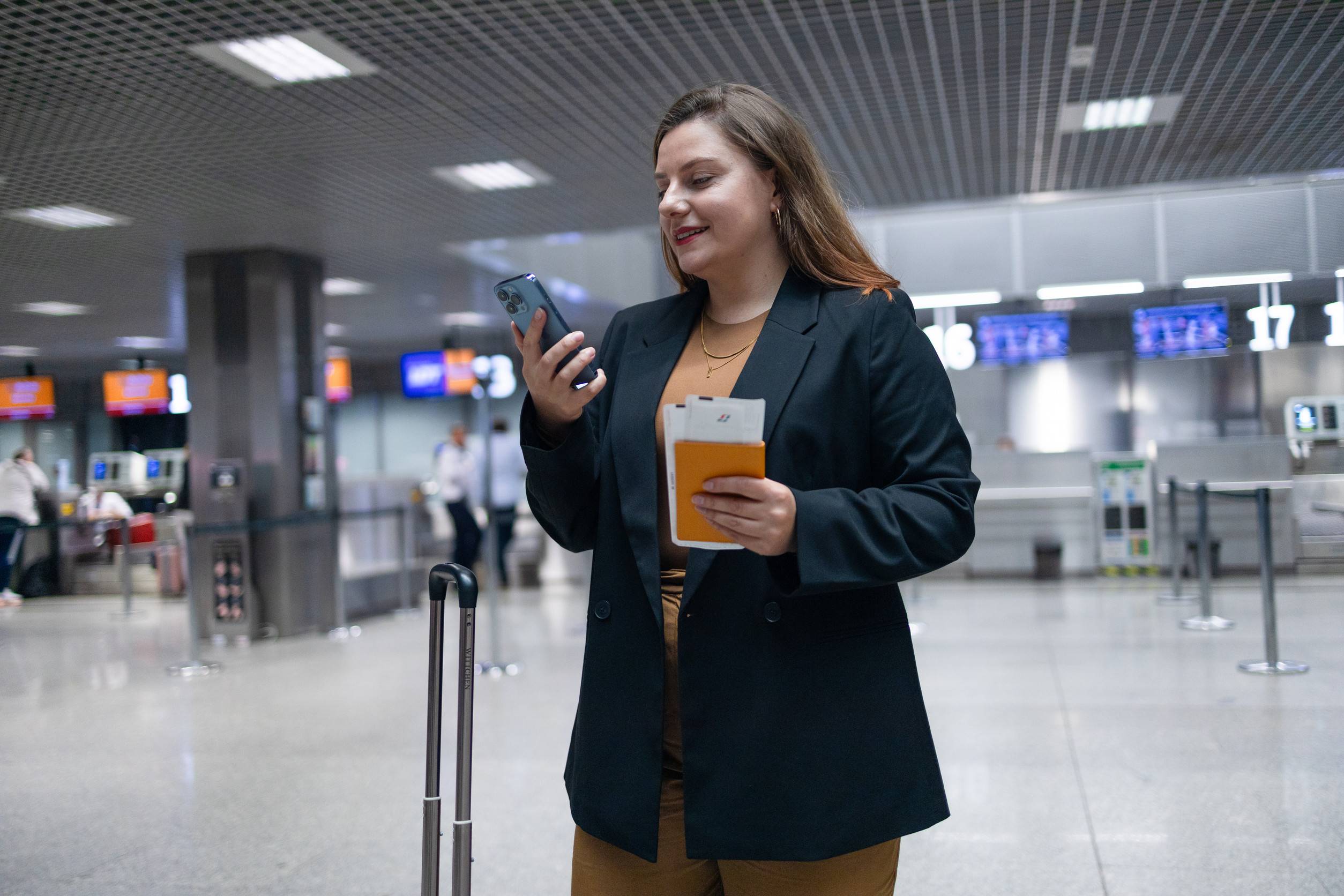 Woman Reading Phone Messages In Airport Happy Female Woman Reading Phone Messages In Airport Happy Female